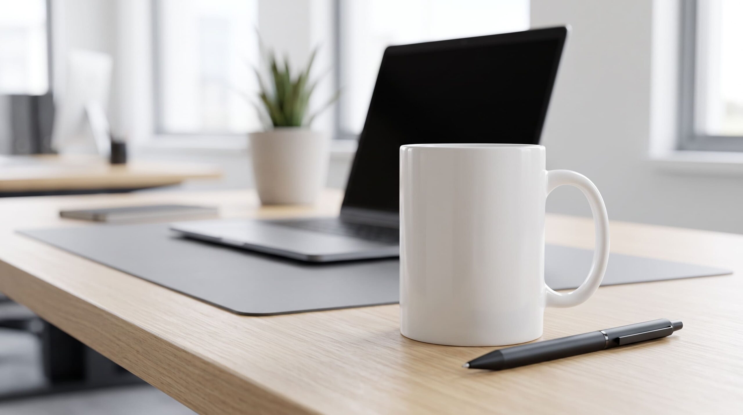 A branded coffee mug with a company logo sits on an office desk, a classic example of Promotional Products.